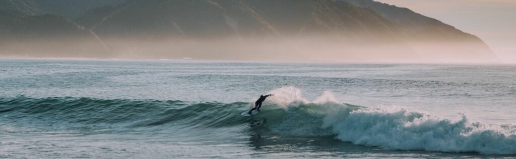 lone surfer on a long right hand point break
