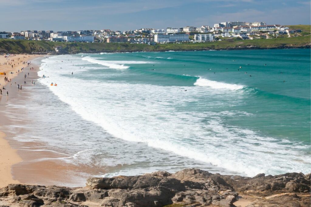 surfers out at high tide north fistral in Newquay